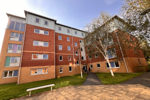 Enlli Hall- 5 story building, cladded in brick. First floor in dark yellow, 3 middle in brown, top floor in light green