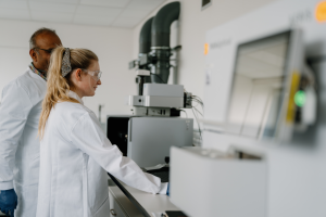 Two researchers in white lab coats looking at a screen at Bangor University's Nuclear Futures Institute