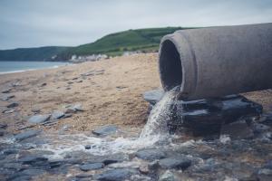 A large sewage pipe on the beach