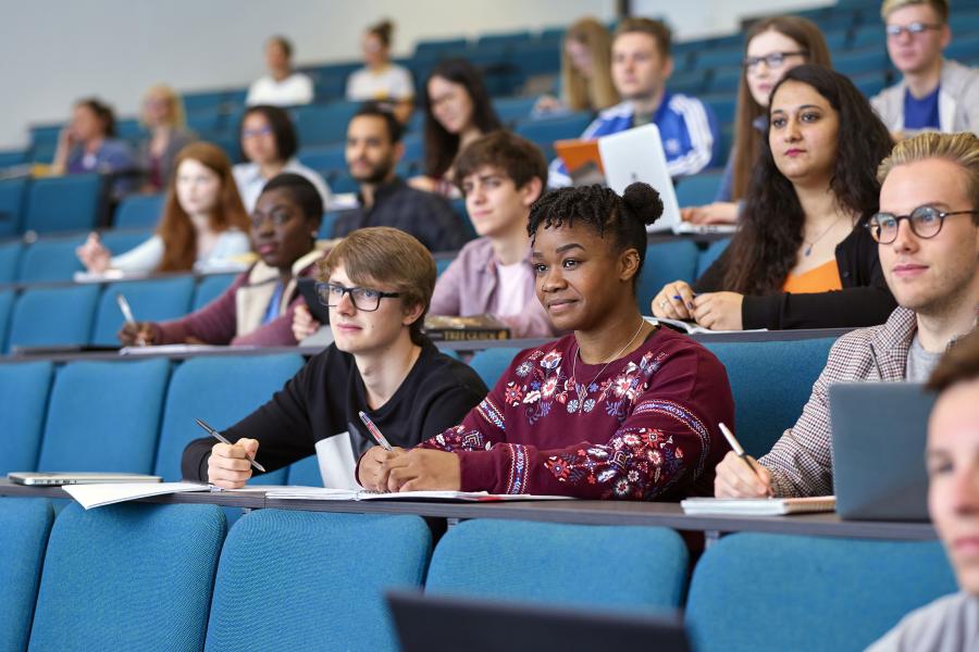 Students taking notes in a lecture theatre