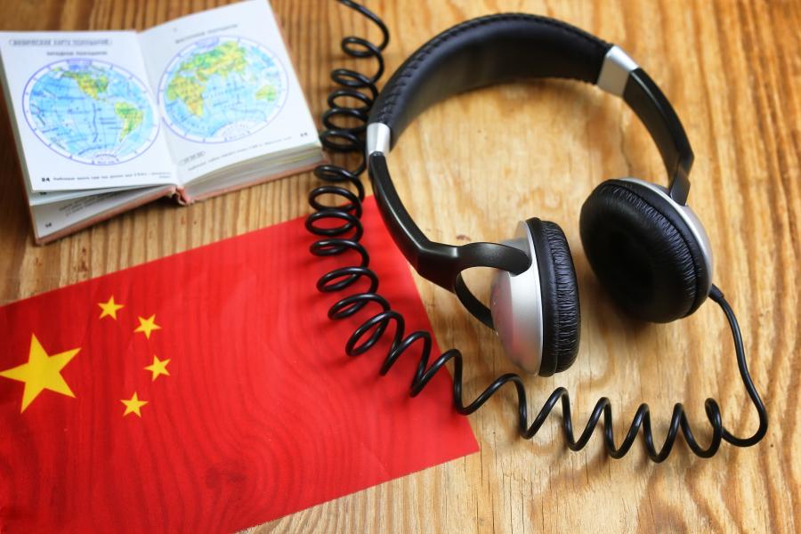 Table with headphones, book and Chinese flag