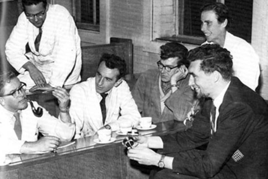 An old photo of students and academics talking to each other, Bangor University