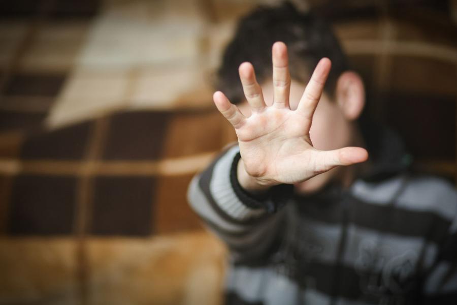 Child with his hand up to the camera