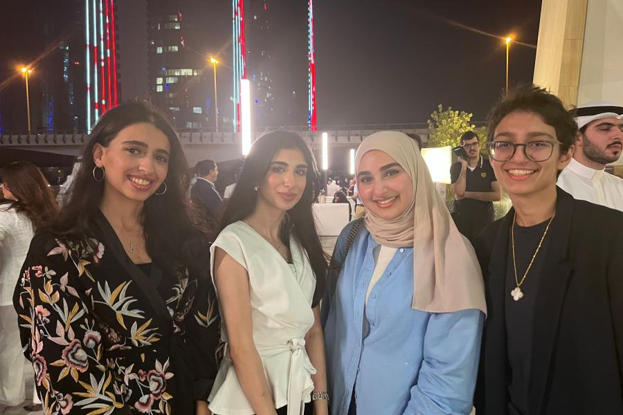 Four guests smiling at the camera during Bahrain reunion 2022