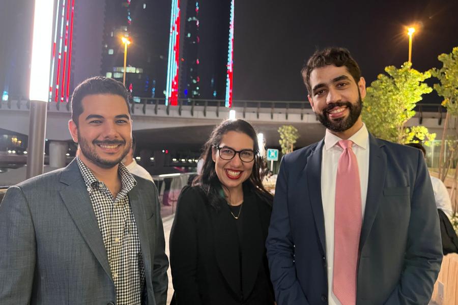 Three guests smiling at the camera during Bahrain reunion 2022