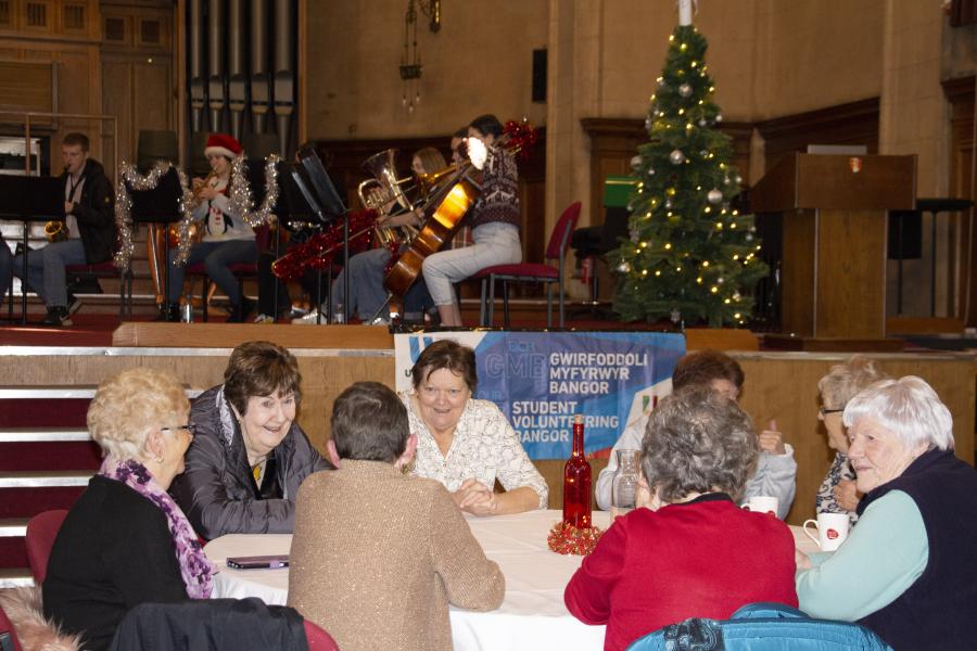 A group enjoying the Tea Party provided by student volunteers at Bangor University