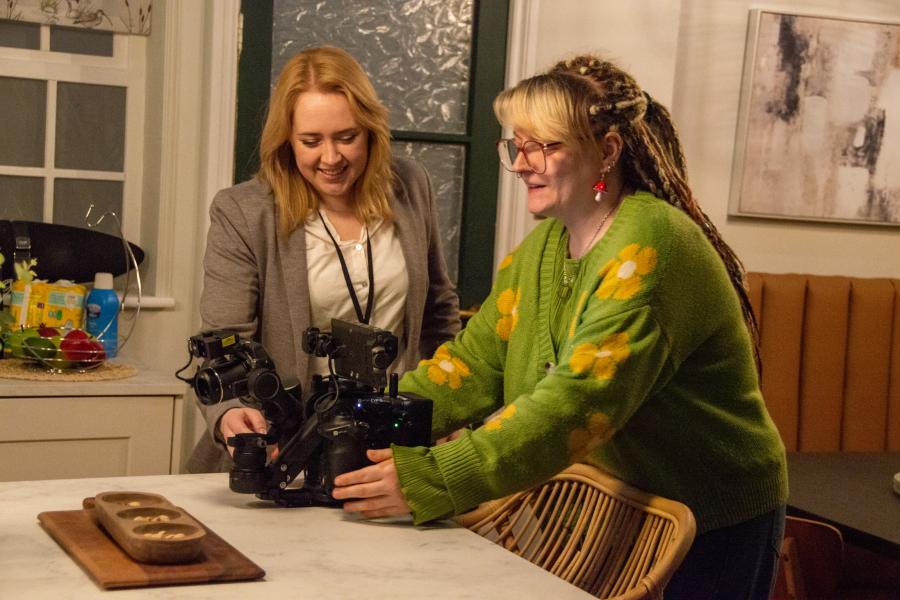 A student being shown a camera at Aria Film Studios