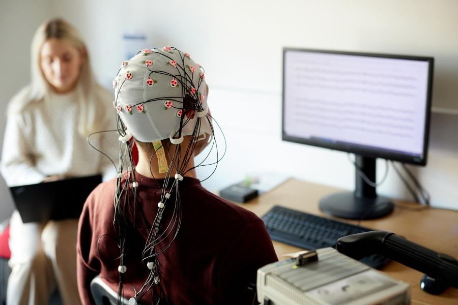 A person is fitted with an electrodes cap in the ERP lab in Bangor University