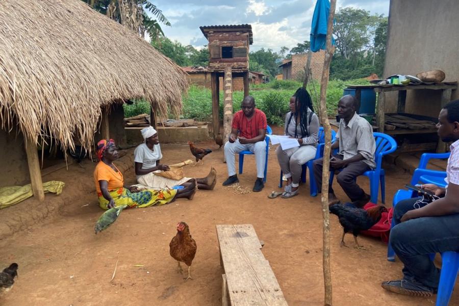 a group of people outside sitting and discussing 