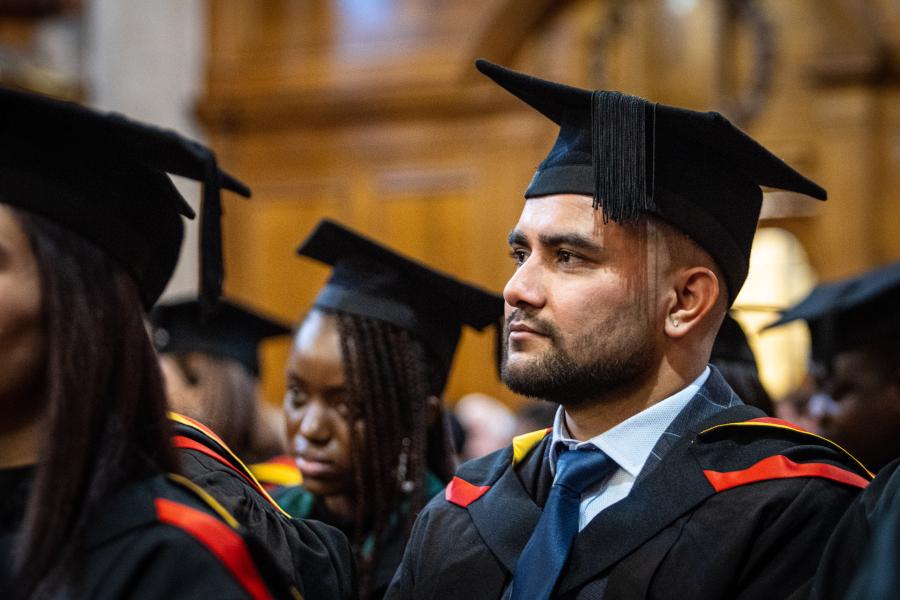 Student looking ahead with graduation cap