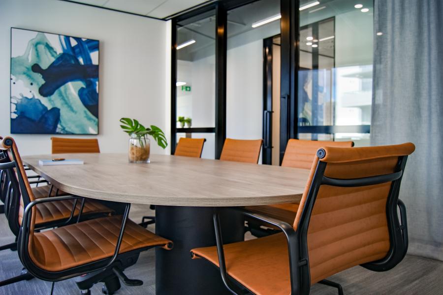 a modern meeting room filled with chairs and painting on the wall 