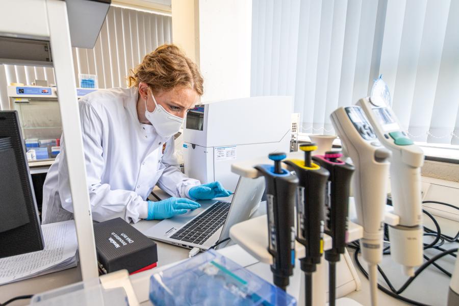 Person testing samples in a lab