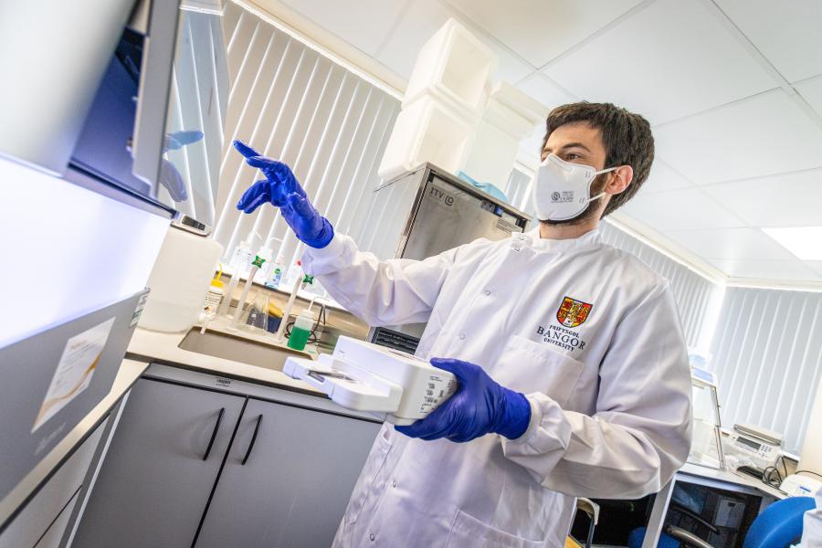 Person testing samples in a lab