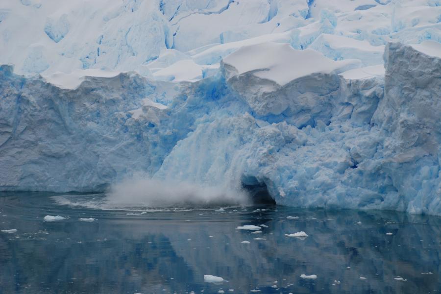 Ice glacier falling into sea