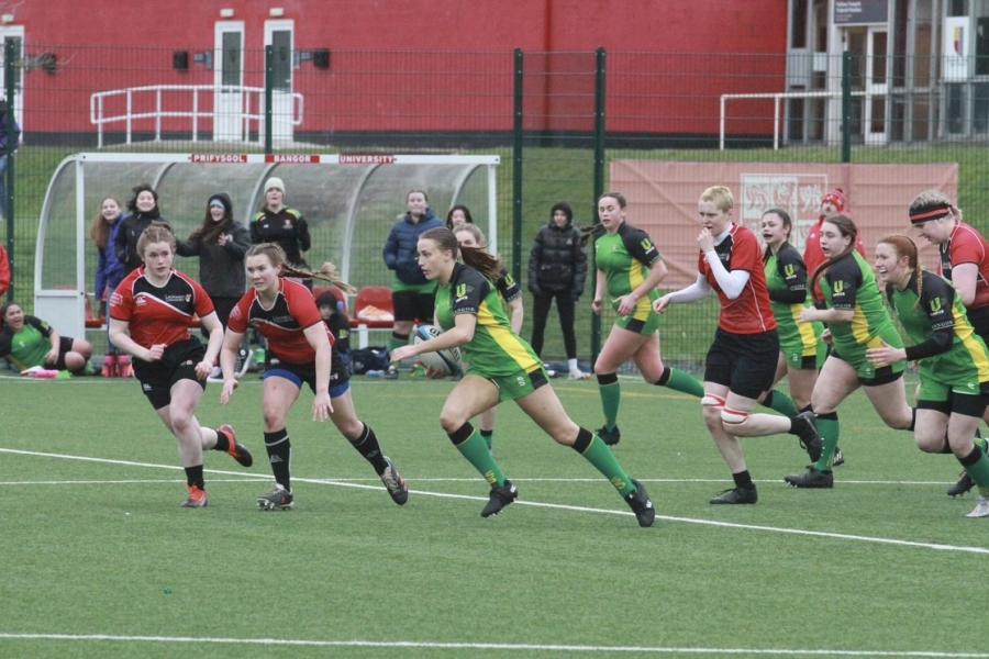 Kate is seen running in the middle of the field, surrounded by players