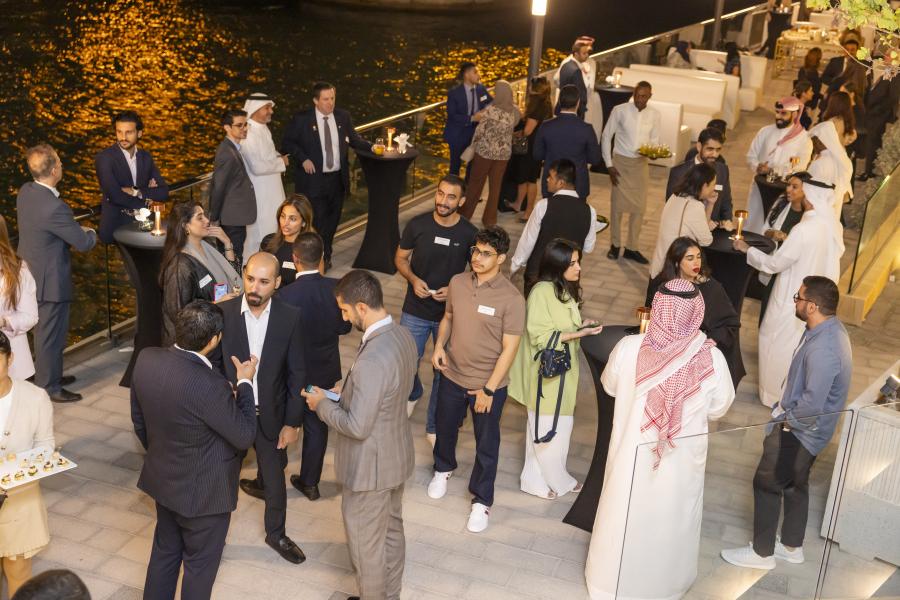 Crowd of alumni enjoying 2023 Bahrain reunion