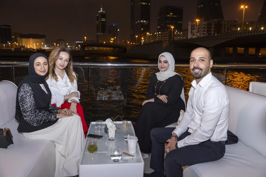 Four alumni sitting at Bahrain reunion