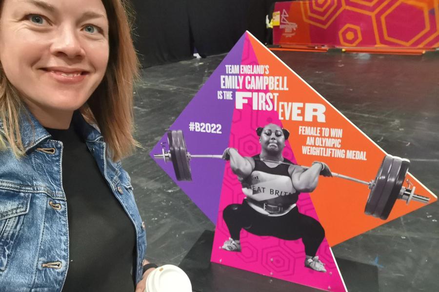 Eleri Jones, smiling, near a weightlifting stand