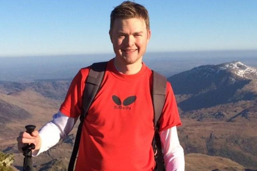 Andy Cooke, wearing a red tshirt, up on the mountains