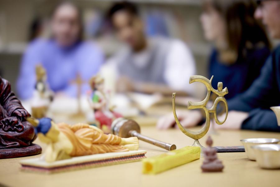 Religious models on table with students looking at them 