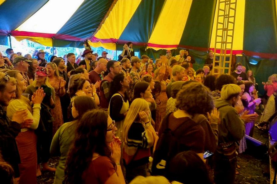group of people, green and yellow circus tent 