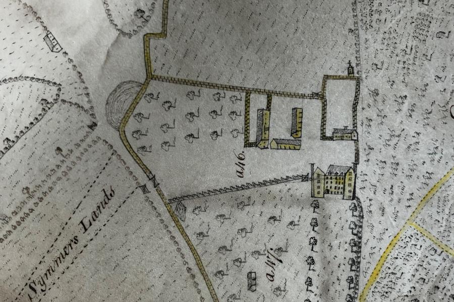 Extract from an historic map showing a country house and outbuildings.