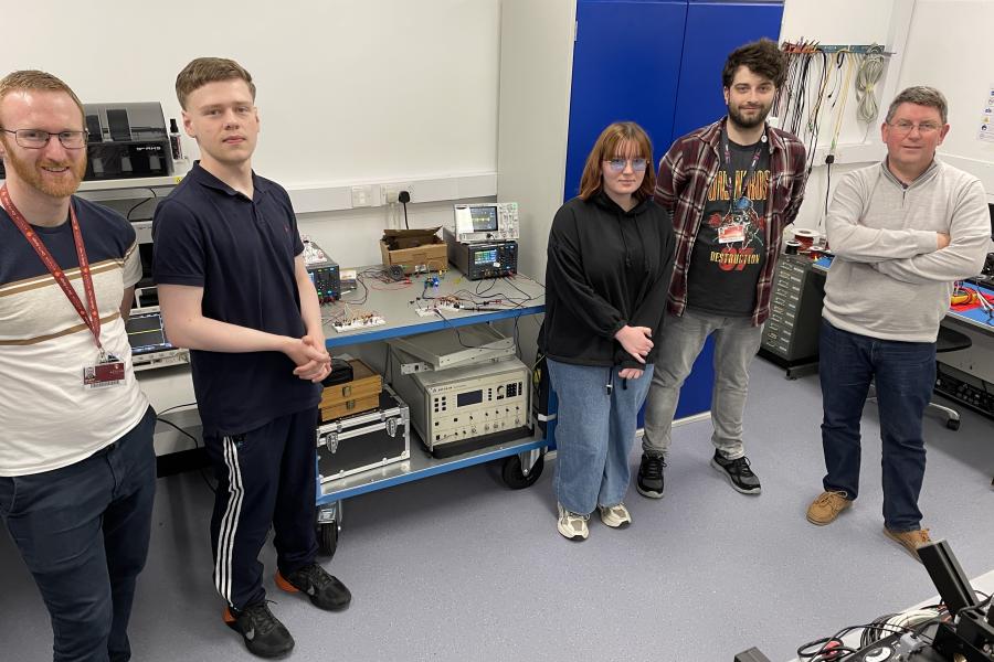 Photo of two 6th form students with DSP Centre staff and their Destination STEM placement project