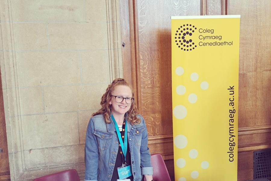 Coleg Cymraeg Branch Officer manning a stall at an open day