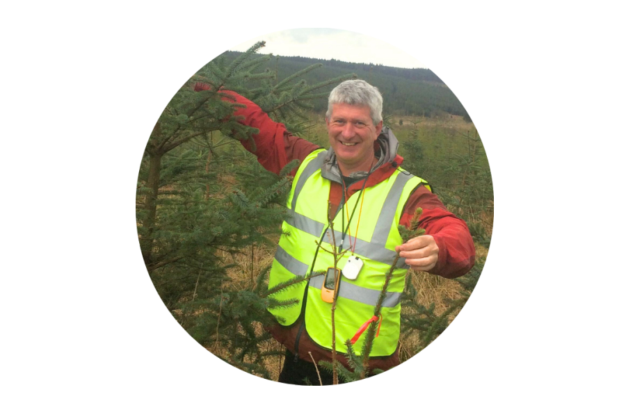 Photo of Prof Andy Smith in hi vis jacket in a wooded area