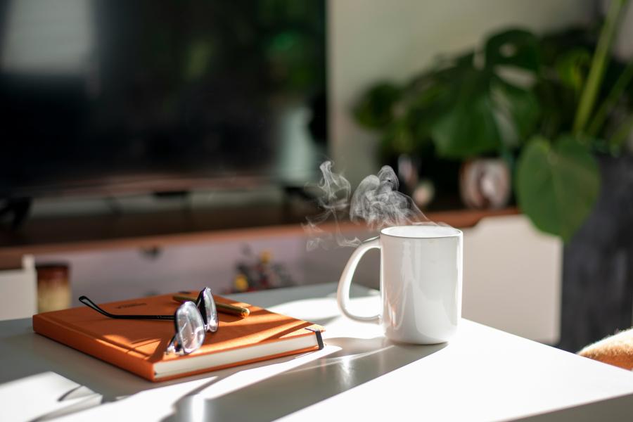 Image of a cup and book on a table