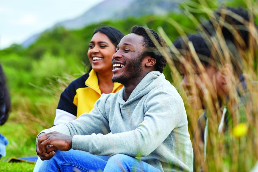 A group of students socialising in a scenic area