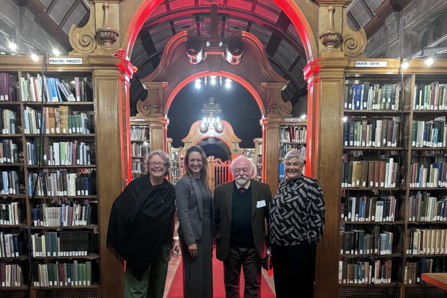 Four people posing in Shankland Reading Room