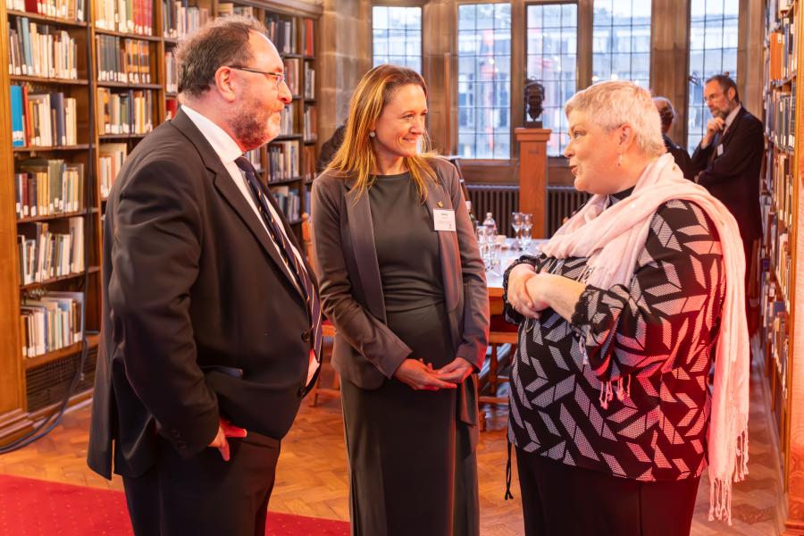 Three people in conversation in the Shankland Reading Room