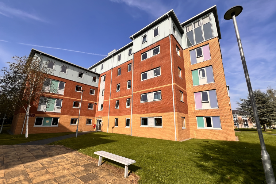 5 story building, facade in pale brown, brown and white