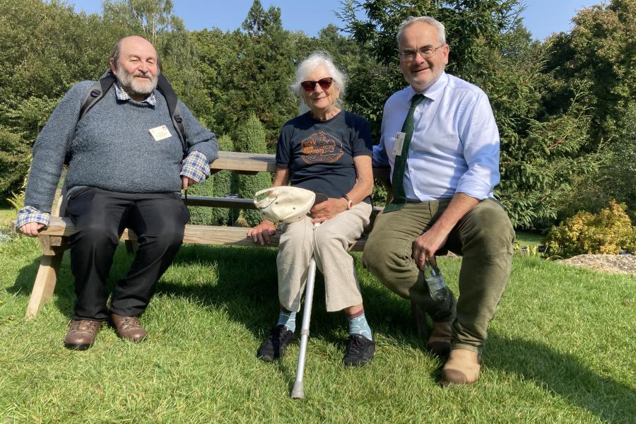 Three people on a picnic bench