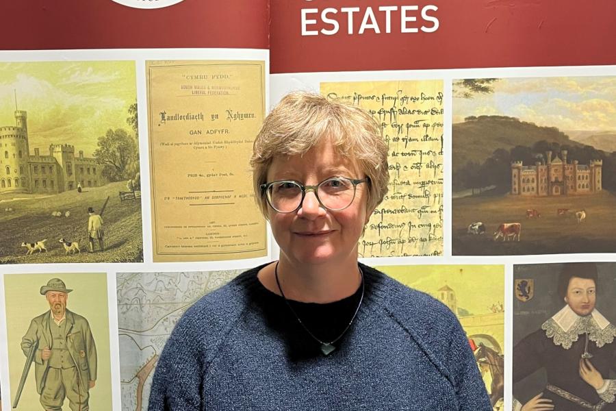 A photograph of doctoral student Hannah Jones standing in front of the ISWE banner