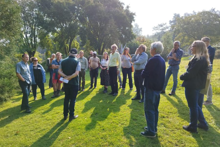 Group of people in Treborth, listening to speaker