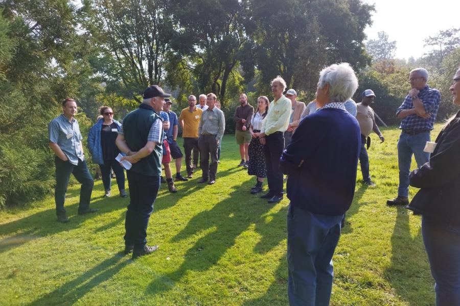 Group of people in Treborth, listening to speaker