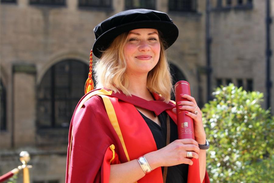 Dr Nia Griffith on graduation day in graduation robes and graduation cap