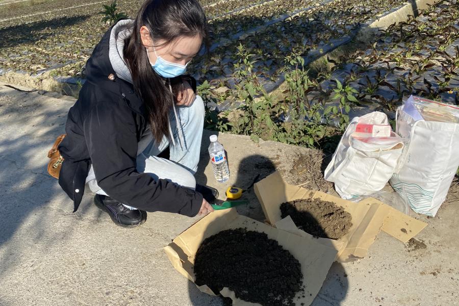 This is a photo of Siyang Ren collecting soil in Yunnan Province in southwest China.