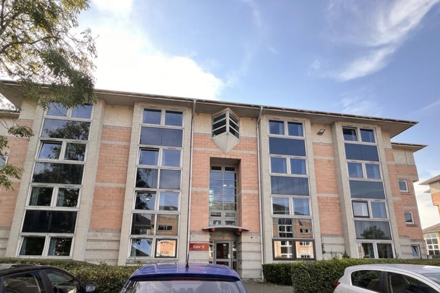 Image of Elidir Hall, with trees, parking location and blue sky