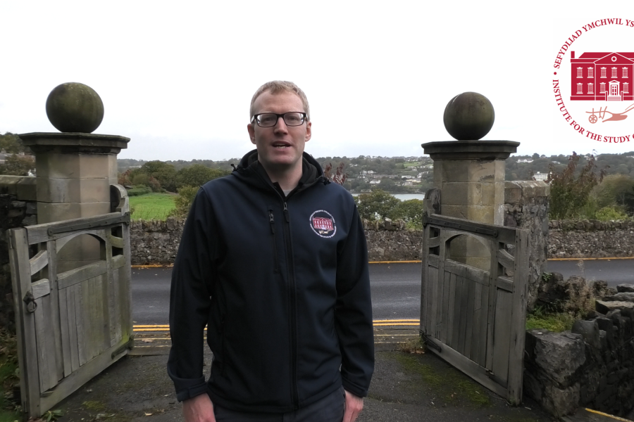 Dr Shaun Evans, Director of ISWE, talking to the camera, on Bangor University premises, overlooking the Menai Straits