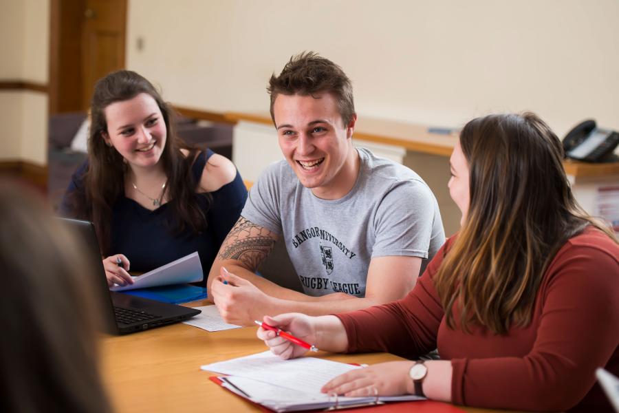 Students sharing a joke during a seminar