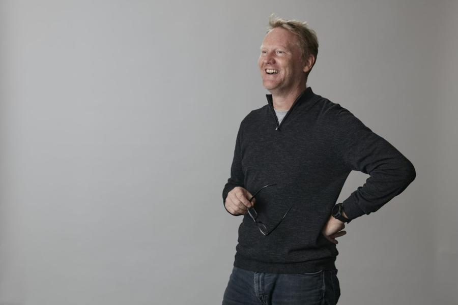 Prof Davey Jones stands in front of grey background