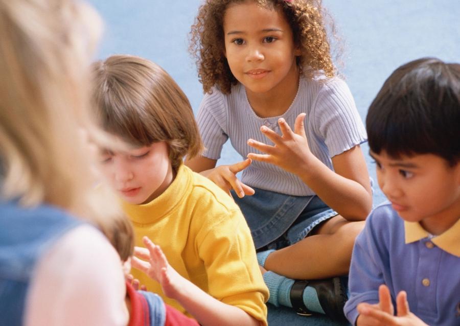 Three children counting with an adult