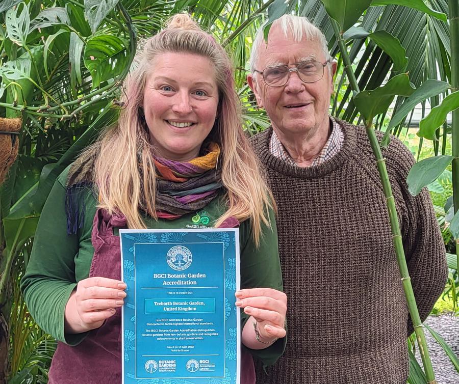 Image of Natalie holding a certificate with Paul