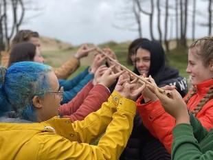 People holding a stick