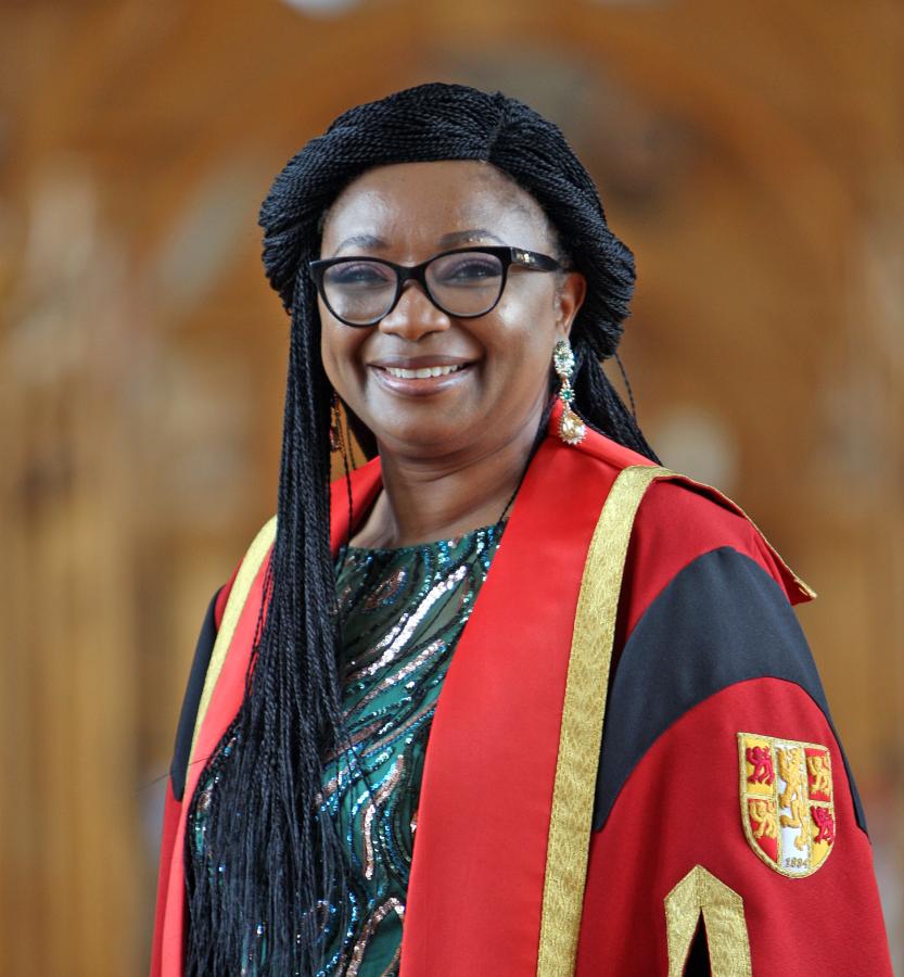 Dr Salamatu Jidda-Fada in Bangor University Library in graduation gown