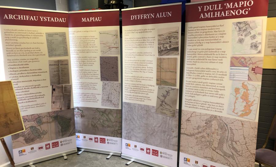 Four exhibition banners full of text and images. 