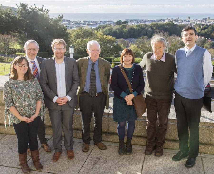 A group of seven people, with views over Bangor in the background.